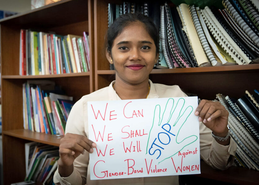 Sri Lanka Womens' Committee with Prithvi Sharujha from the Lanka Eksath Jathika Workers Union and sign saying end gender-based violence, worker rights, Solidarity Center